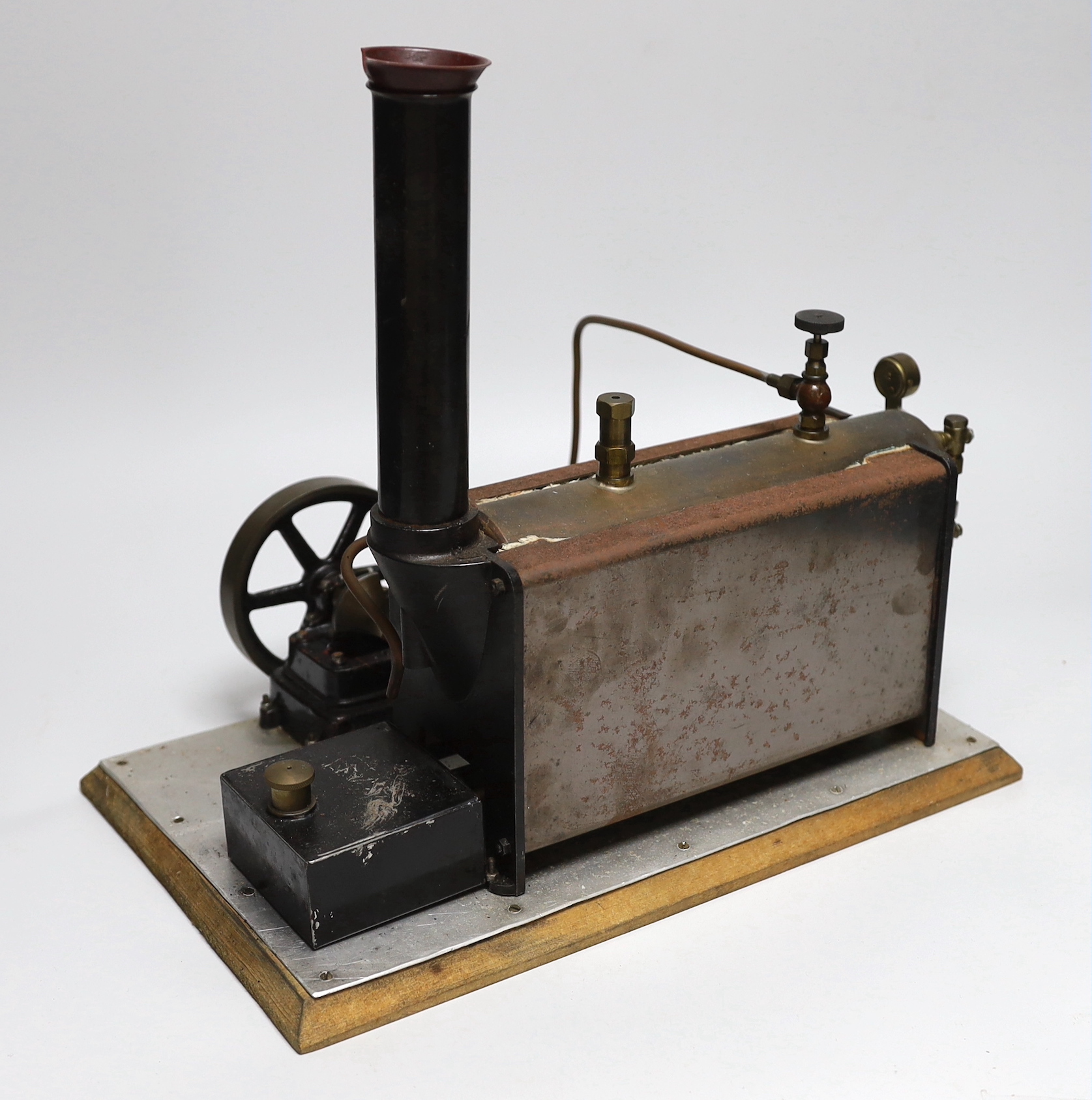 A vintage Stuart Turner model steam engine and boiler mounted on a wooden base, with booklet 33cm wide